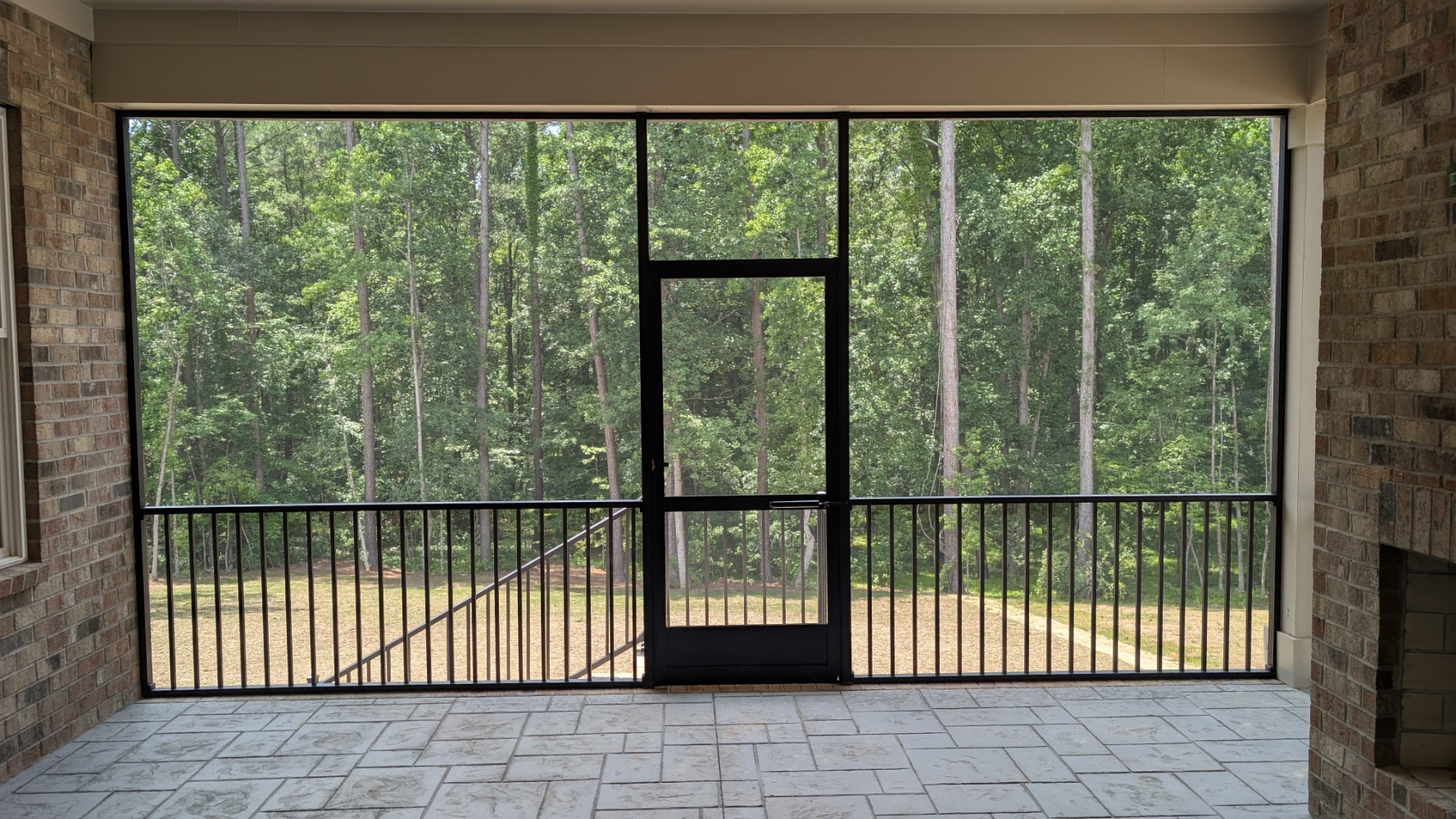 Screened Porch: Interior view with fireplace and screen door