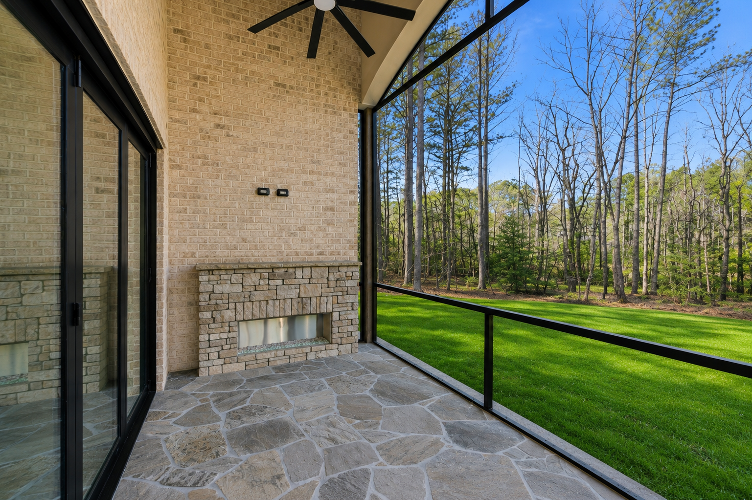Screened Porch: Arched porch interior with stone fireplace