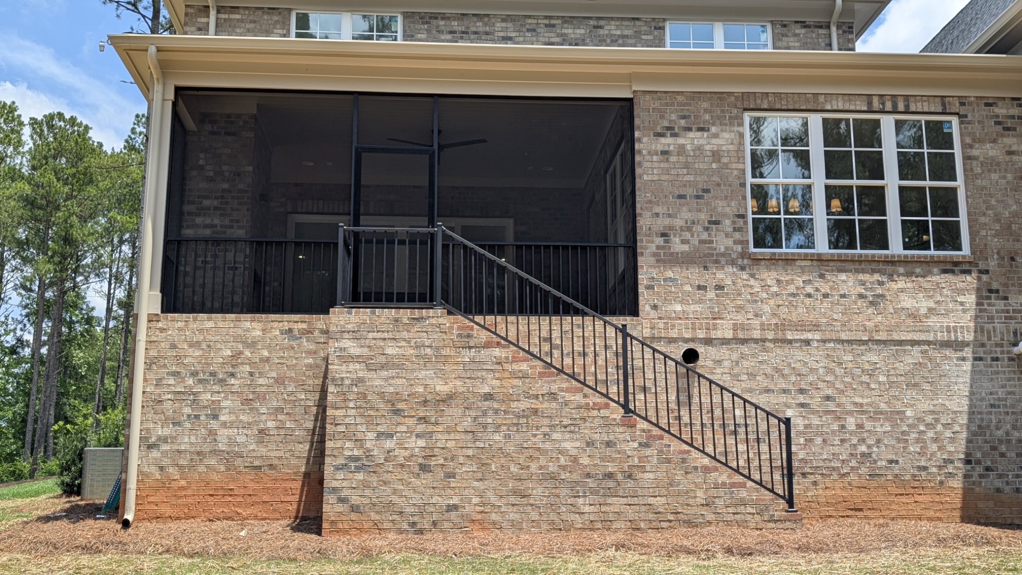 Screened Porch: Elevated brick porch with stair railing